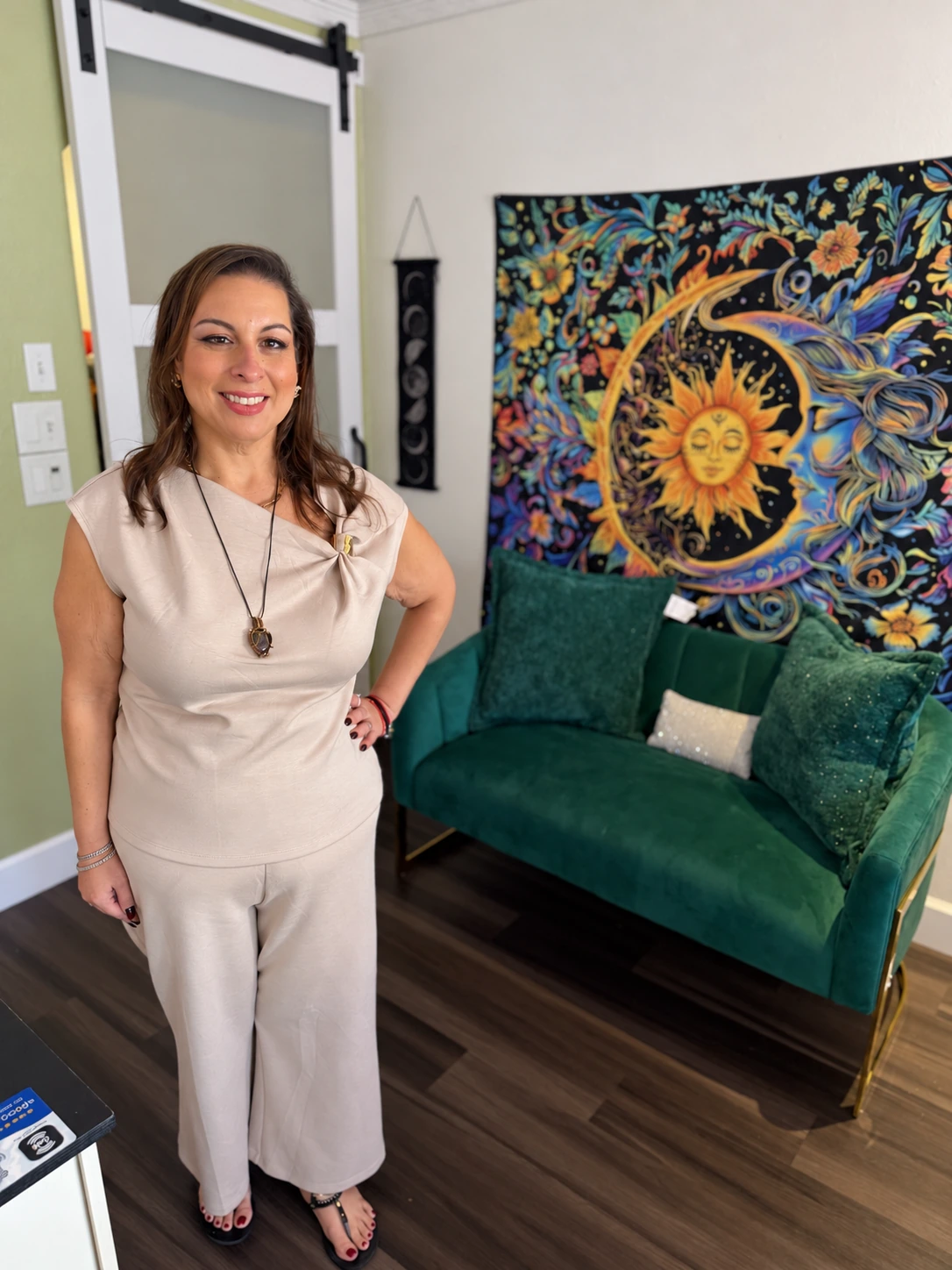 Tina Johnson beside an emerald green sofa at Lake Eola Psychic